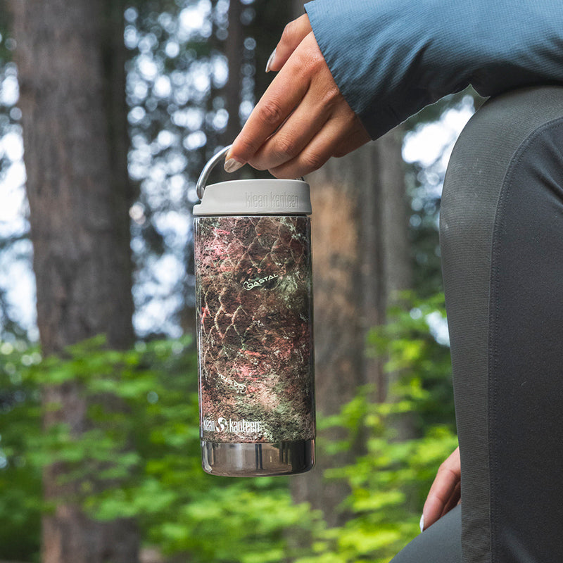 12oz-tkwide-with-twist-cap-mossy-oak-e9 12oz_tumbler_mossyoak_rainbowtrout_hand_closeup_square.jpg